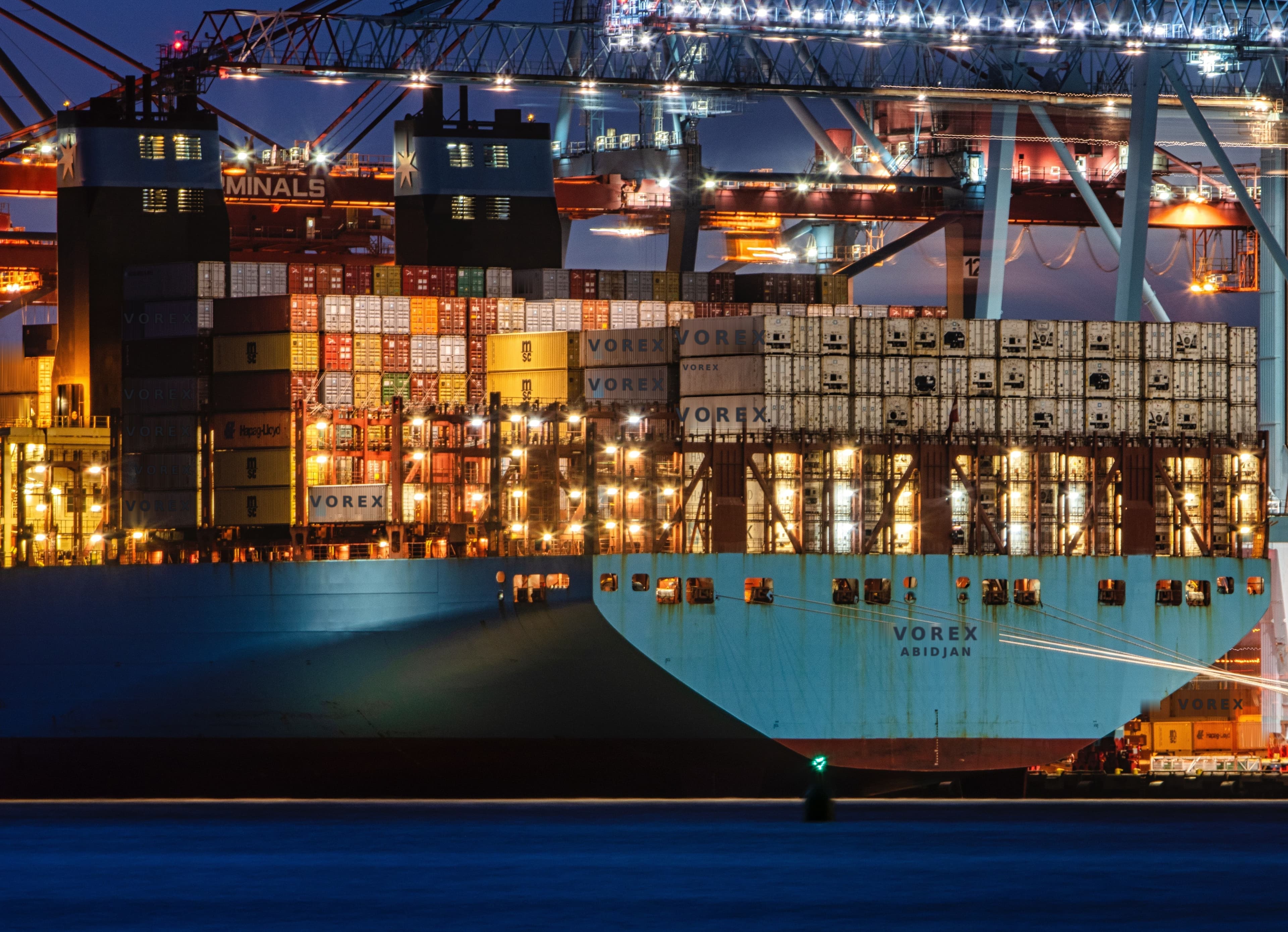 Container ship berthed at a port terminal at night